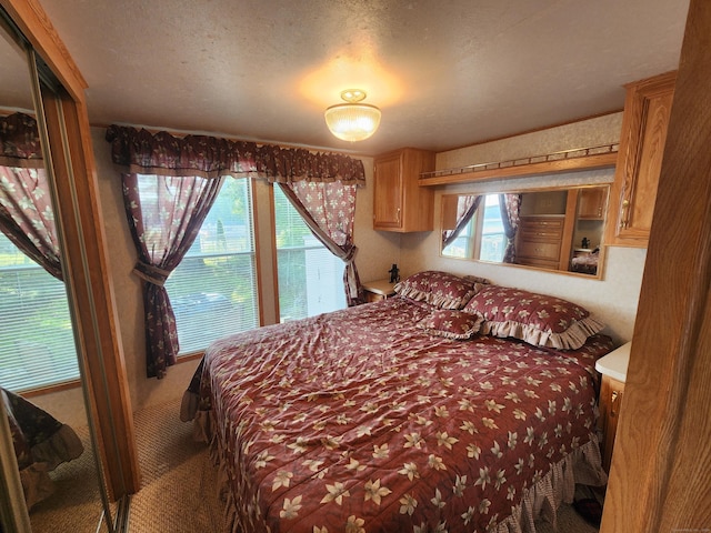 bedroom featuring carpet floors and a textured ceiling