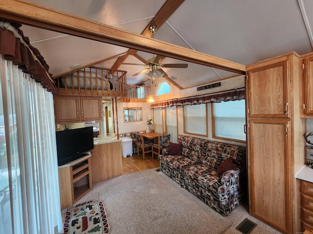 living room with vaulted ceiling with beams, ceiling fan, and light carpet