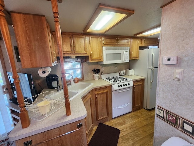 kitchen featuring white appliances and light hardwood / wood-style floors