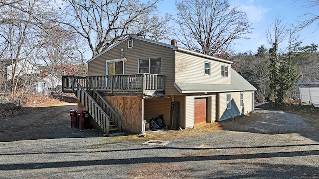 view of front of property with a garage and a wooden deck