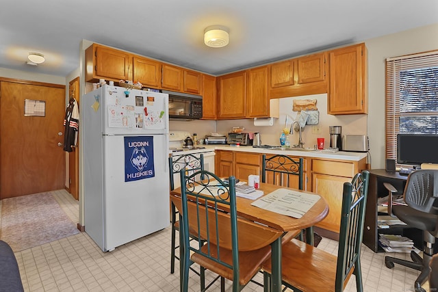 kitchen featuring sink and white appliances