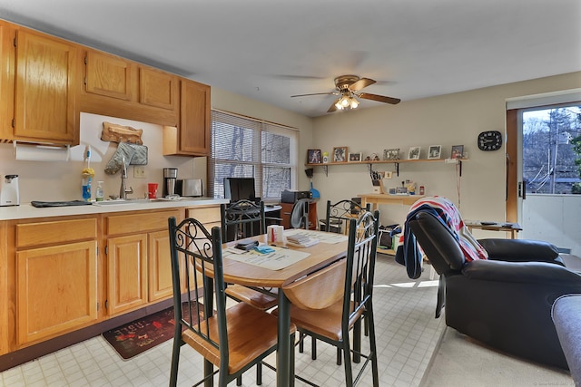 dining space with ceiling fan and sink