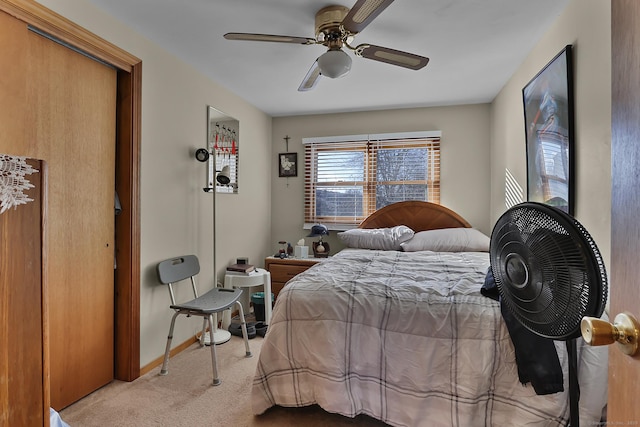 bedroom featuring ceiling fan and light carpet