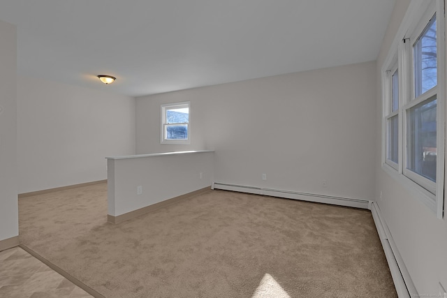 carpeted spare room with baseboard heating