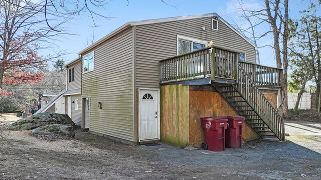 back of house featuring a deck