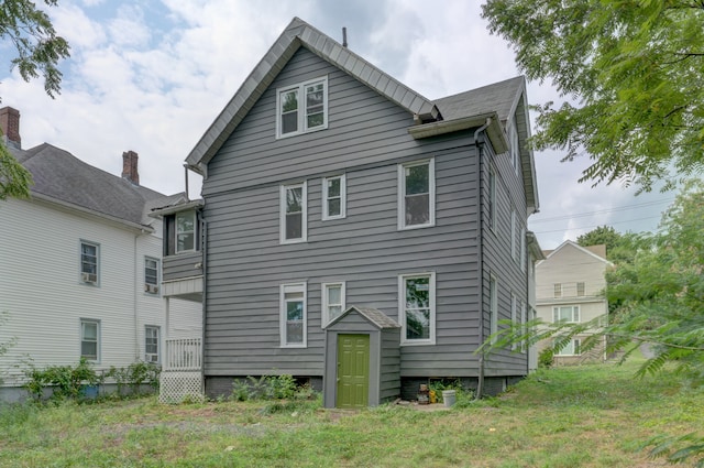 rear view of property with a yard