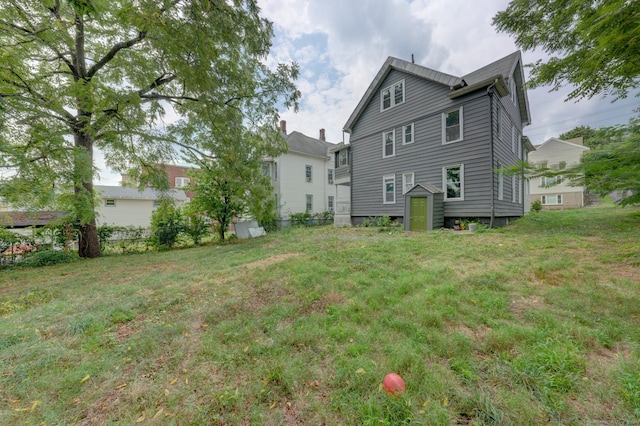 rear view of property with a lawn