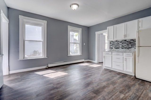 kitchen featuring decorative backsplash, dark hardwood / wood-style flooring, a baseboard heating unit, white cabinets, and white fridge