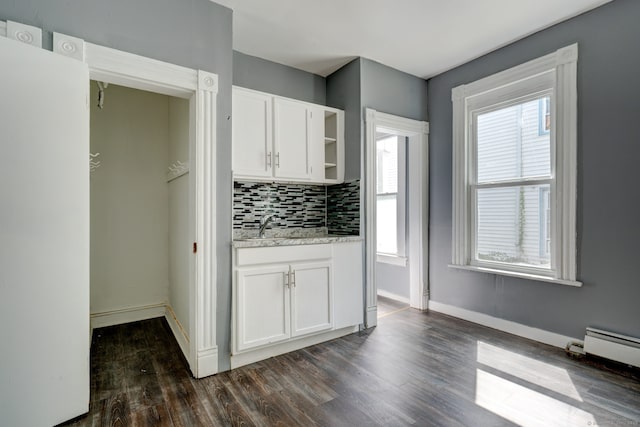 kitchen featuring tasteful backsplash, a wealth of natural light, white cabinetry, and dark wood-type flooring