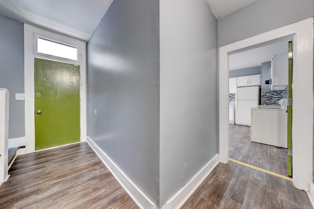 corridor featuring dark hardwood / wood-style flooring and washer / dryer