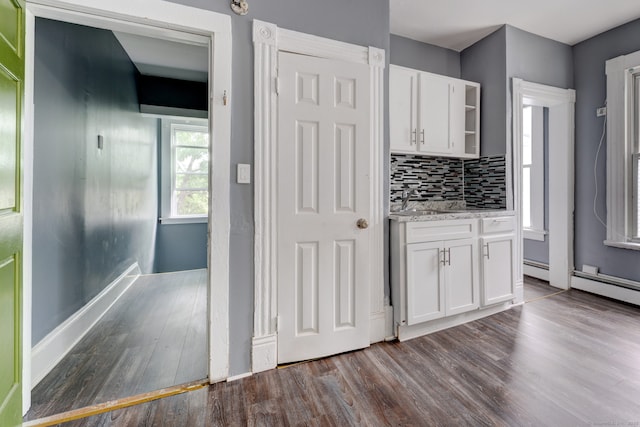 kitchen featuring tasteful backsplash, white cabinets, and dark hardwood / wood-style floors