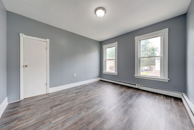 spare room featuring hardwood / wood-style floors and a baseboard radiator