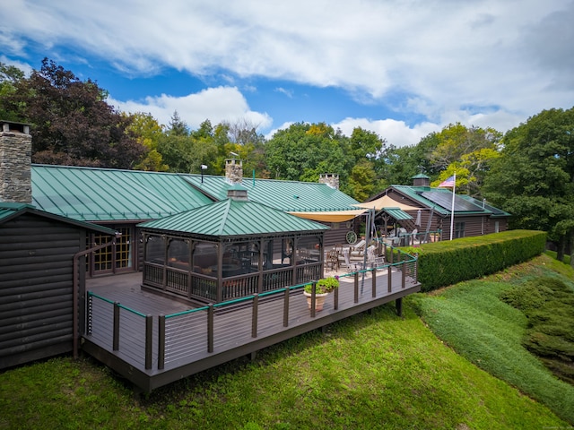 back of property featuring a gazebo and a wooden deck