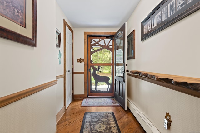 doorway to outside with dark hardwood / wood-style floors and a baseboard radiator