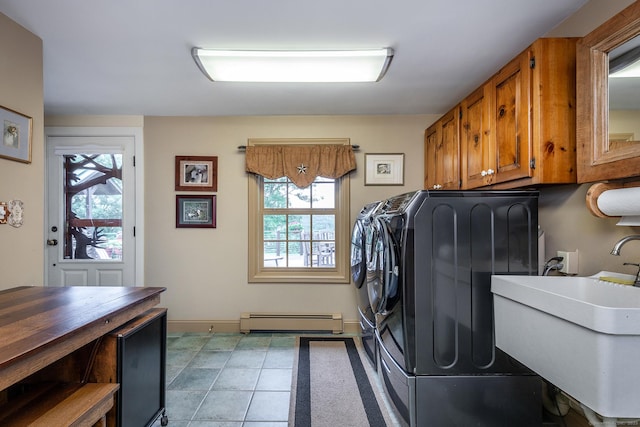 laundry room with cabinets, sink, washer and dryer, light tile patterned floors, and a baseboard radiator