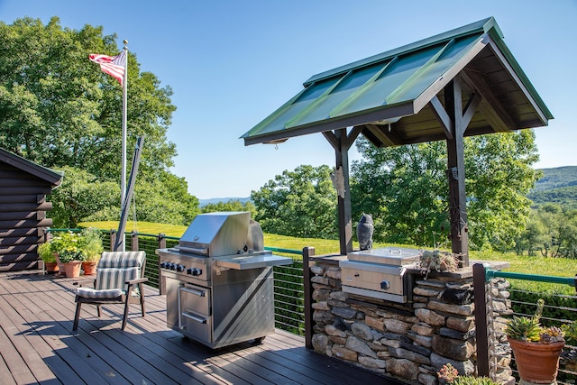 wooden deck featuring area for grilling