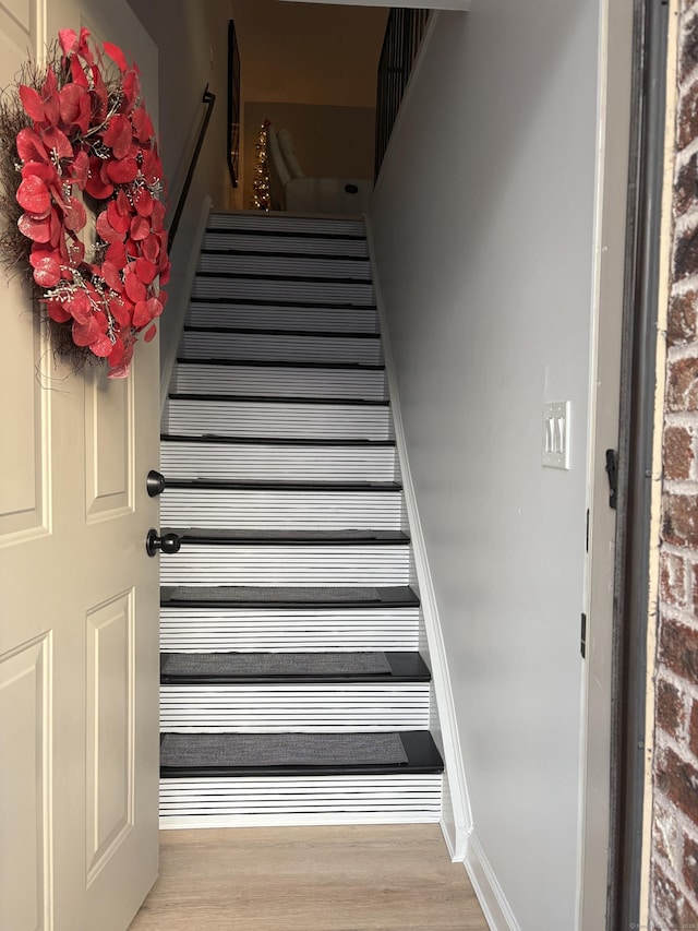 stairs with hardwood / wood-style flooring