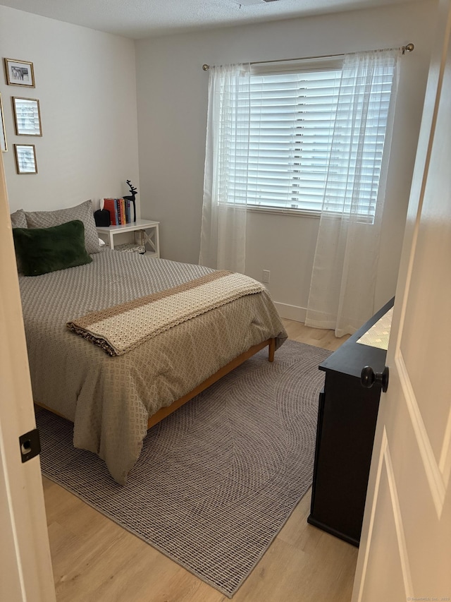 bedroom with light wood-type flooring