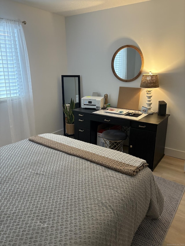 bedroom with light wood-type flooring