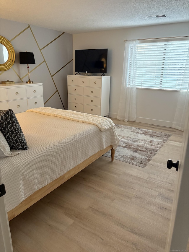 bedroom with light hardwood / wood-style flooring