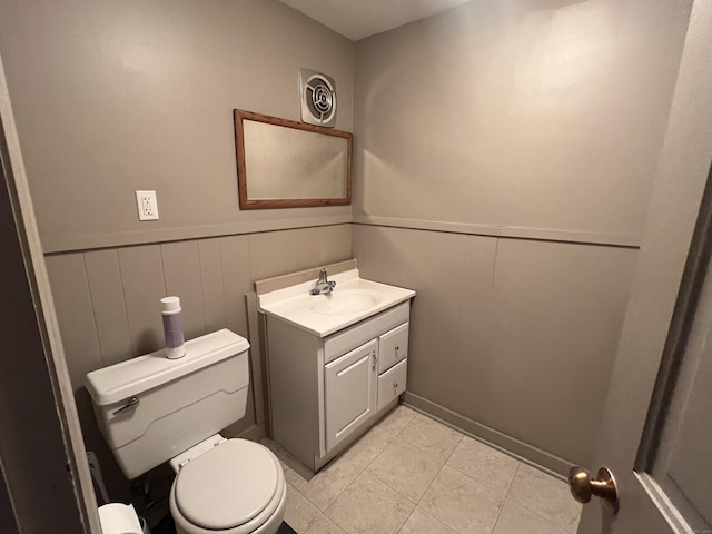 bathroom featuring tile patterned flooring, vanity, and toilet