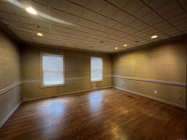 empty room with hardwood / wood-style floors and a healthy amount of sunlight