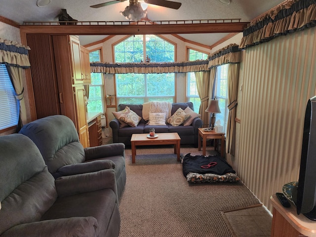 carpeted living room with lofted ceiling with beams, ceiling fan, and ornamental molding