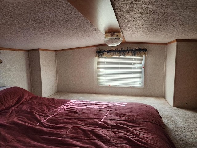 carpeted bedroom with ornamental molding and a textured ceiling