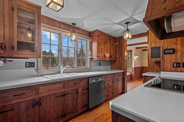 kitchen with dishwasher, sink, black electric cooktop, and hanging light fixtures