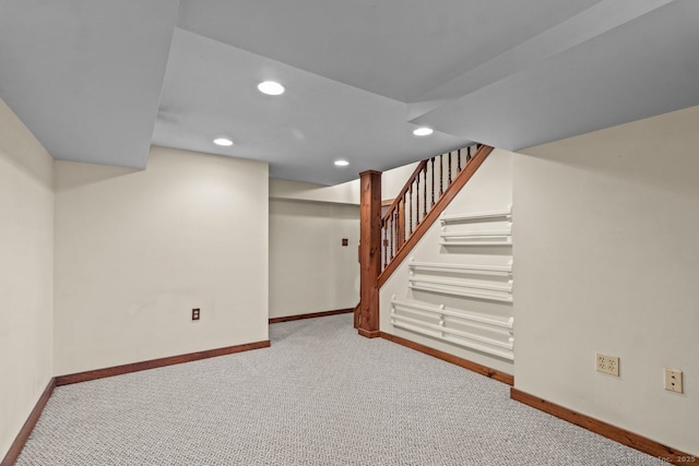 basement featuring light colored carpet