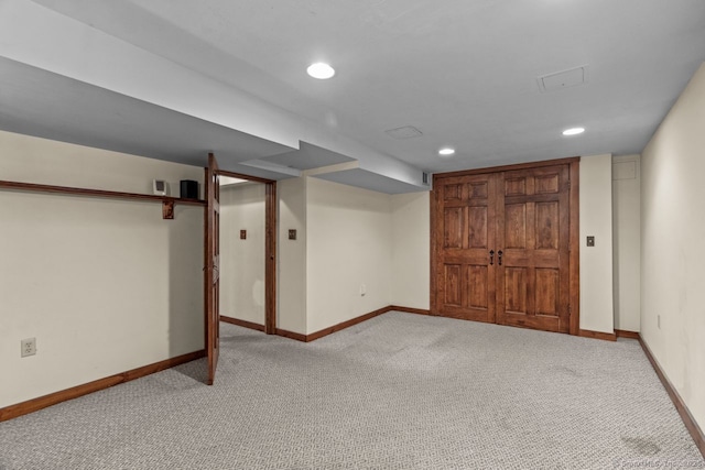 basement featuring light colored carpet