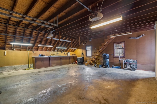 garage with a workshop area and a garage door opener