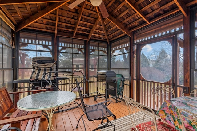 sunroom featuring vaulted ceiling with beams, ceiling fan, and wood ceiling