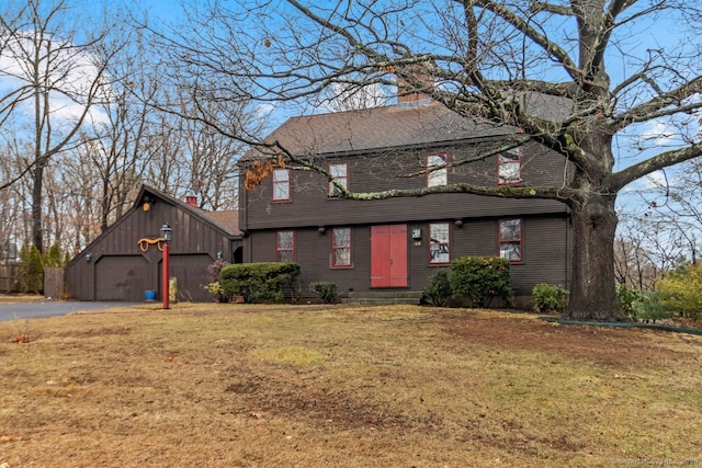 view of front of house with a front yard and a garage