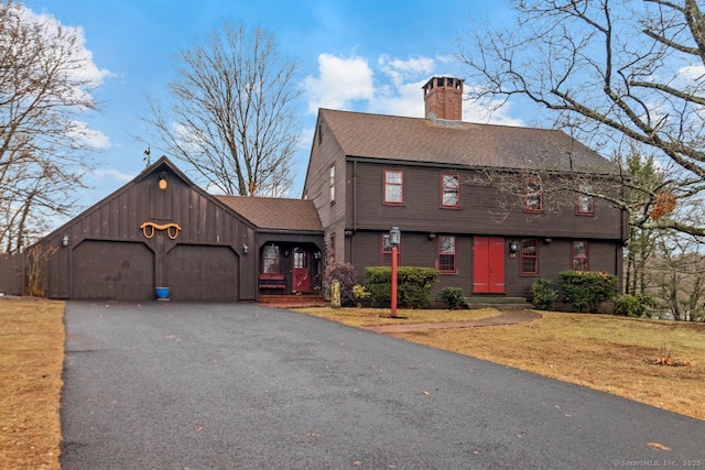 view of front of property with a garage and a front lawn