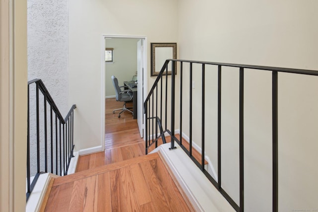 stairs with wood-type flooring