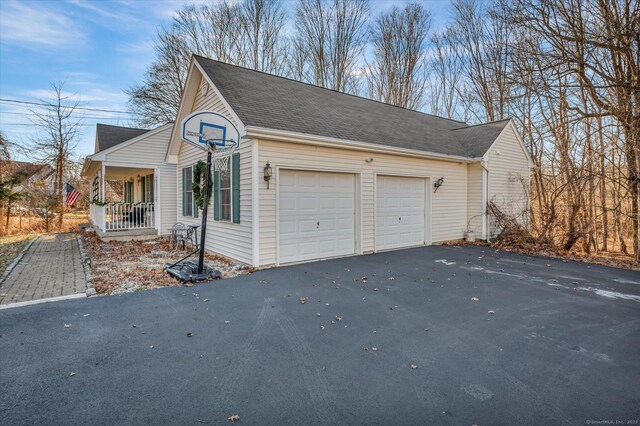 view of side of property with a porch and a garage