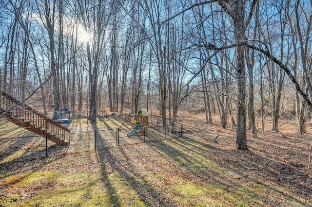 view of yard with a playground and a trampoline