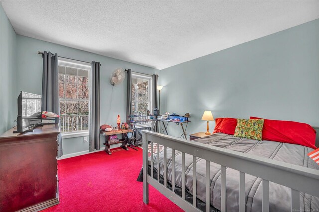 carpeted bedroom featuring a textured ceiling