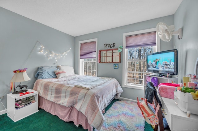 carpeted bedroom with multiple windows