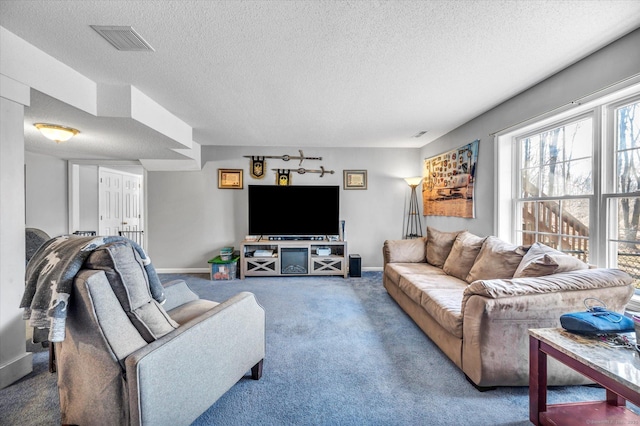 living room with carpet floors and a textured ceiling