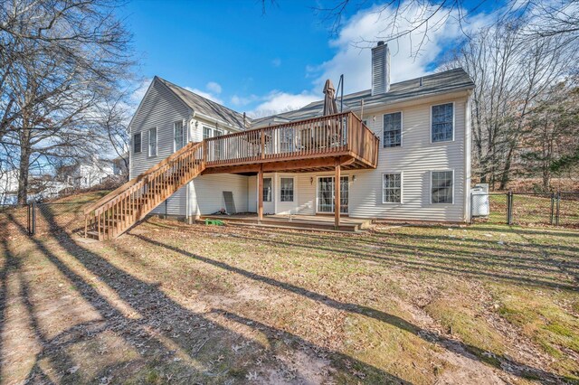 back of house with a lawn and a wooden deck