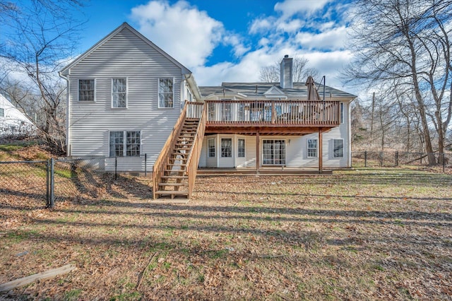 back of house with a yard and a wooden deck