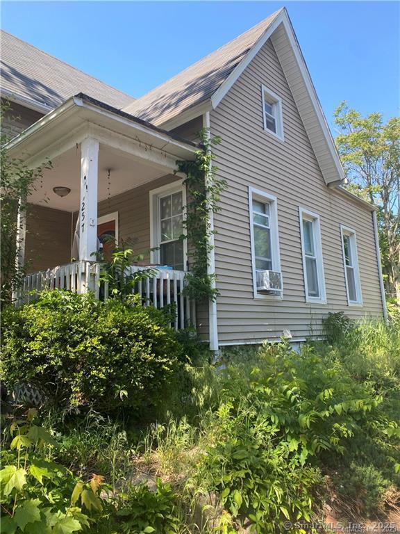 view of side of property featuring a porch