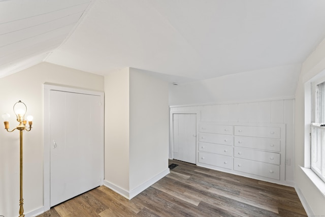 additional living space with dark hardwood / wood-style floors and lofted ceiling