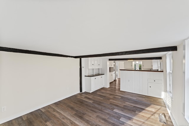 unfurnished living room featuring dark wood-type flooring