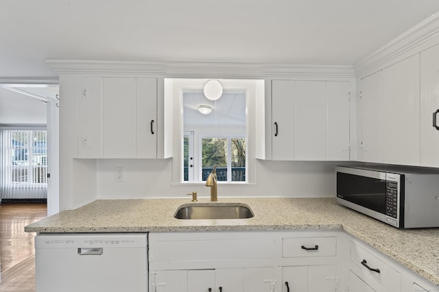 kitchen featuring dishwasher, white cabinetry, and sink