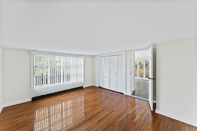 unfurnished bedroom featuring a closet and wood-type flooring