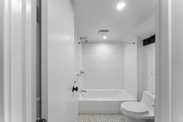 bathroom featuring tile patterned floors, bathing tub / shower combination, and toilet