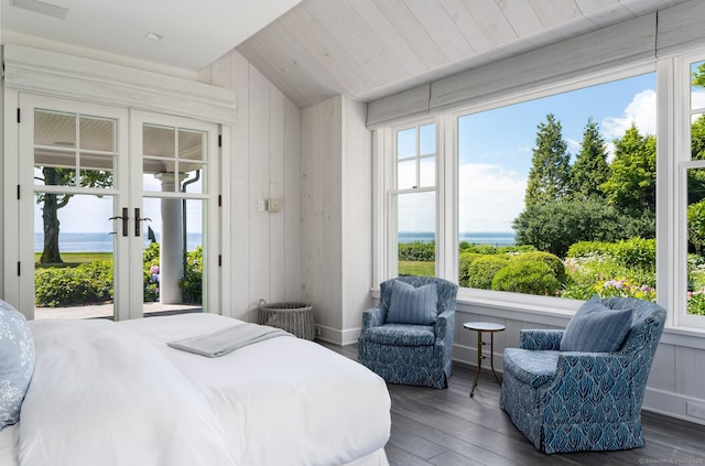 bedroom with lofted ceiling, access to outside, french doors, and wood finished floors